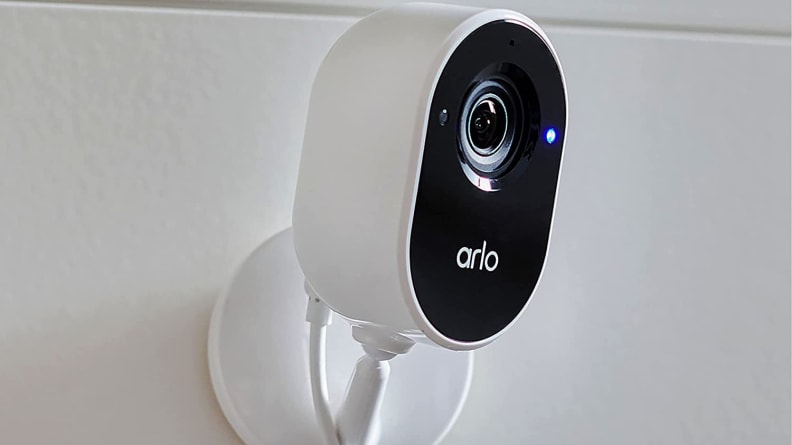 White and black smart camera mounted on the wall.