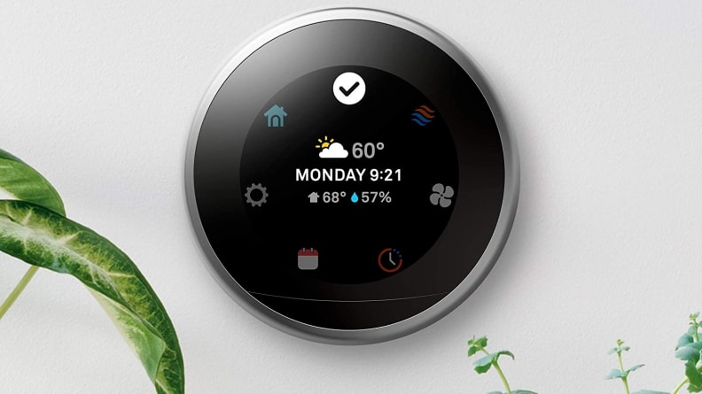 LED display on wall mounted circular smart thermostat.