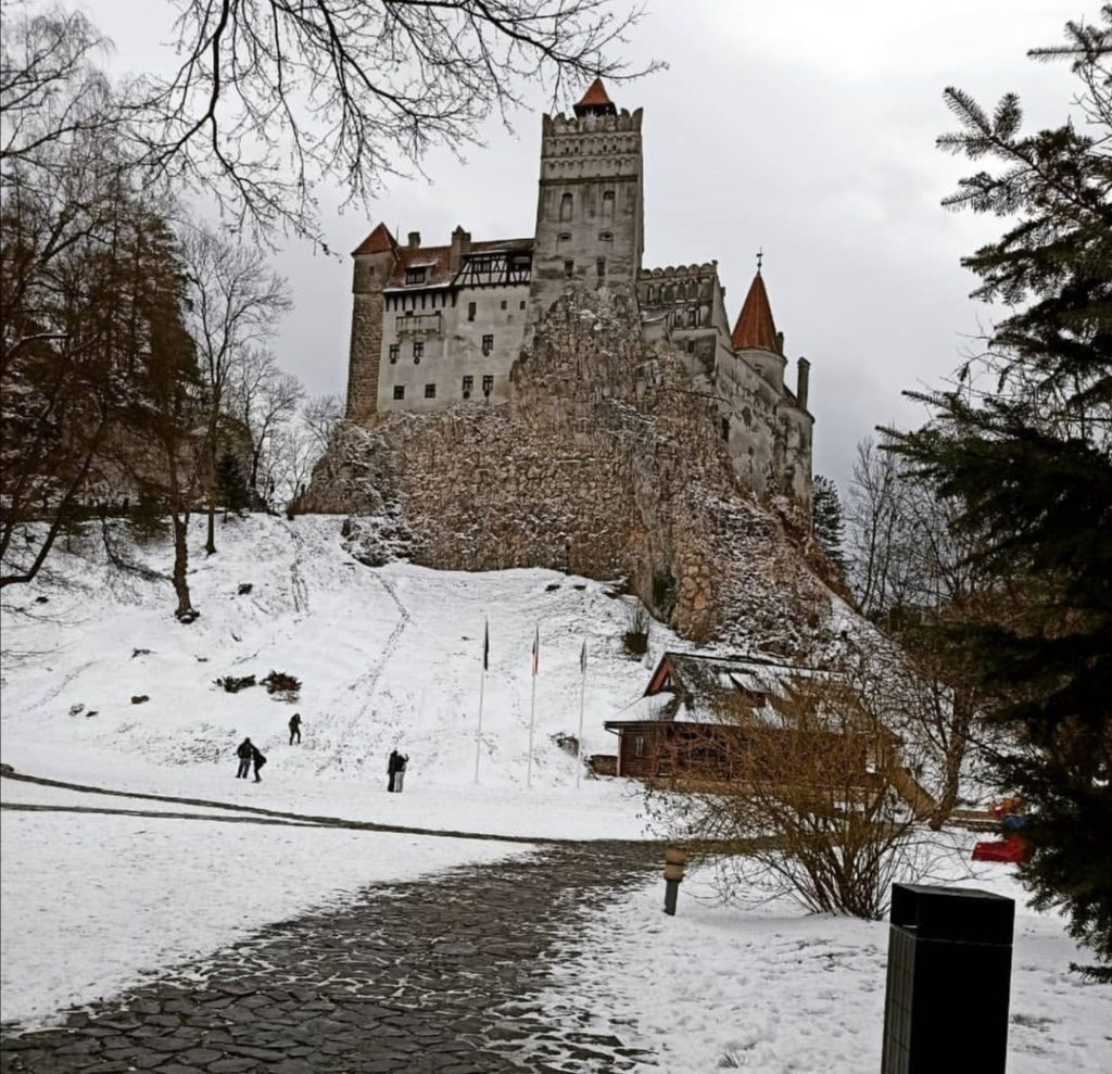 To know Transylvania: Bran Castle covered in snow in winter.
